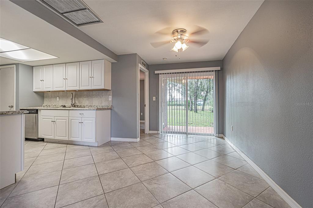 1529 Larkin Road Spring Hill, FL 34608 - Photo 4 of 37 a view of a kitchen with dishwasher and white cabinets