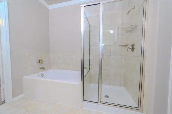 a white bath tub sitting next to a shower
