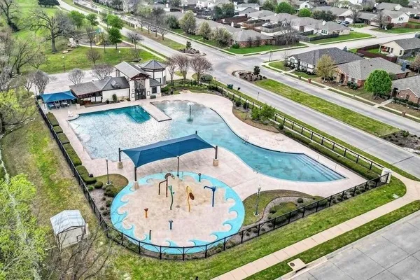 a view of a swimming pool with a yard