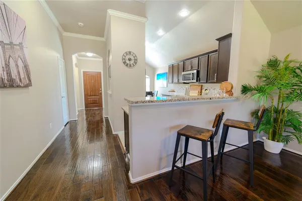 a kitchen with granite countertop white cabinets and stainless steel appliances