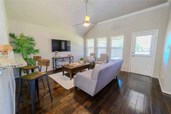 a living room with furniture and a flat screen tv