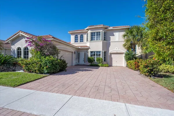 a front view of a house with a yard and a garage