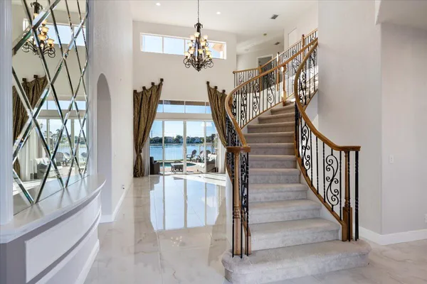 a view of a livingroom with furniture staircase and front door