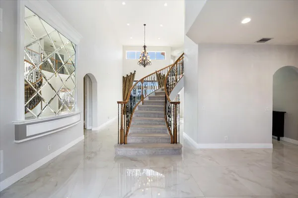 a view of entryway and hall with wooden floor