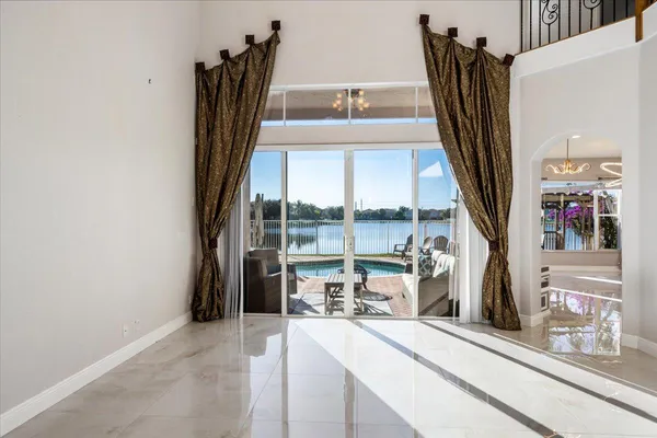 a view of a living room with a floor to ceiling window and storage
