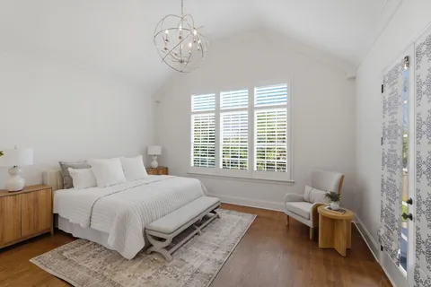 a spacious bedroom with a bed and a window