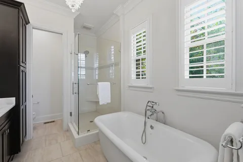a bathroom with a tub shower and sink