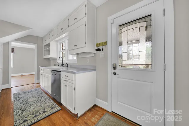 a kitchen with white cabinets and white appliances