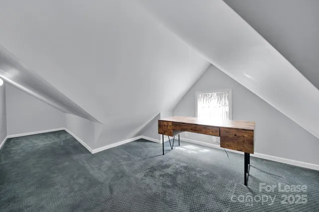 a view of room with furniture and windows