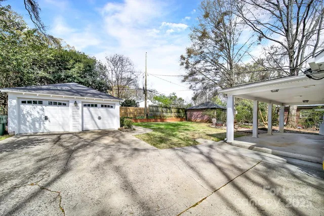 a view of a house with a yard and garage