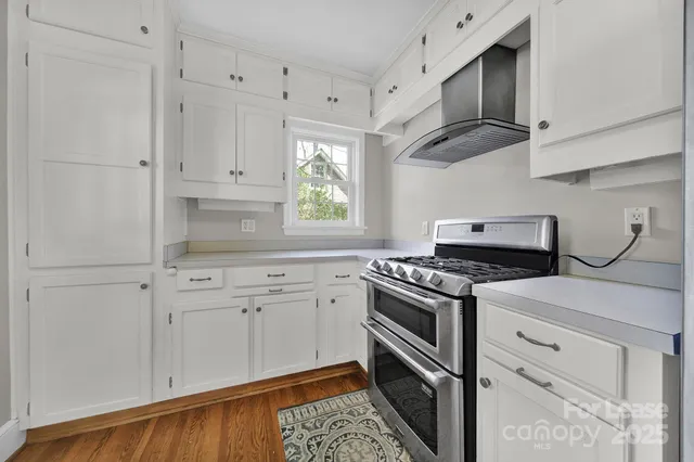 a kitchen with cabinets appliances and a window