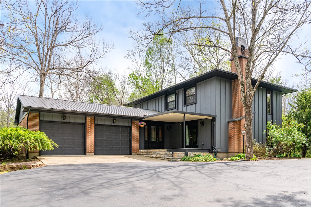 6750 Little Twin Road Germantown, OH 45327 - Photo 1 of 88 This residence features a distinctive exterior with a spacious driveway and surrounding mature trees.