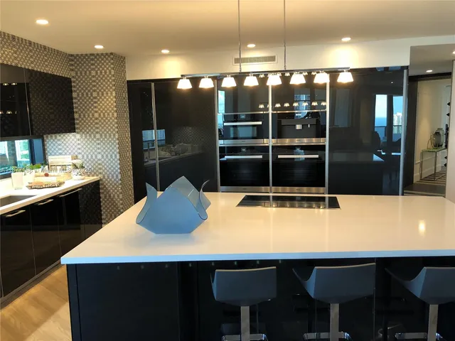 a kitchen with a table chairs sink and window