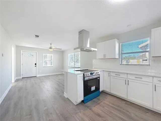 a kitchen with granite countertop a stove and a sink
