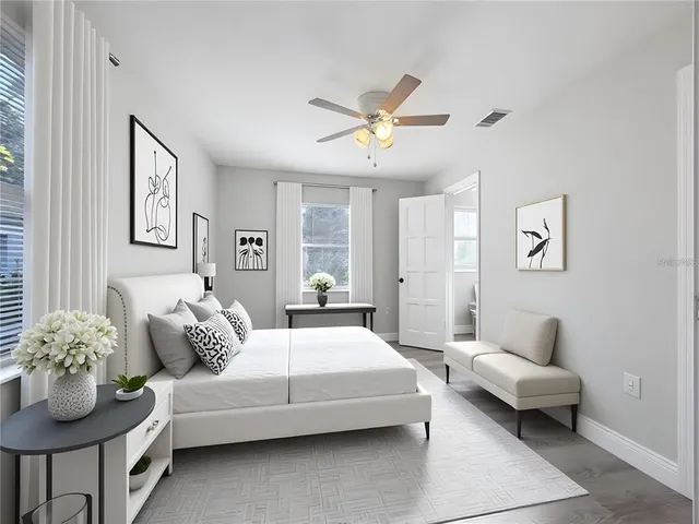a living room with furniture and a potted plant