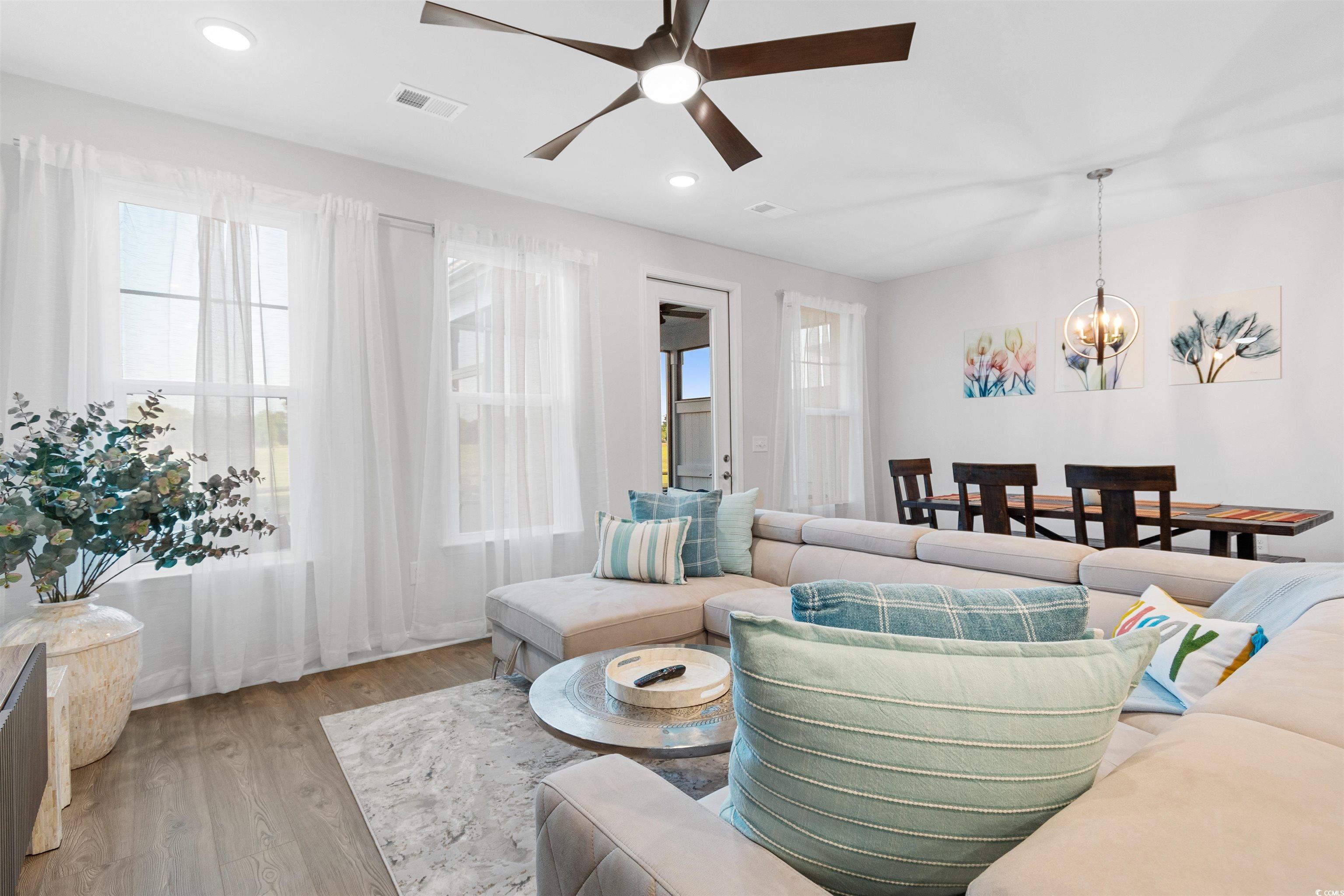 5117 Double Eagle Way North Myrtle Beach, SC 29582 - Photo 3 of 20 Living room with healthy amount of natural light, wood finished floors, a chandelier, a ceiling fan, and recessed lighting