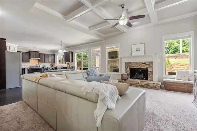 a kitchen with granite countertop wooden cabinets a center island stainless steel appliances and a window