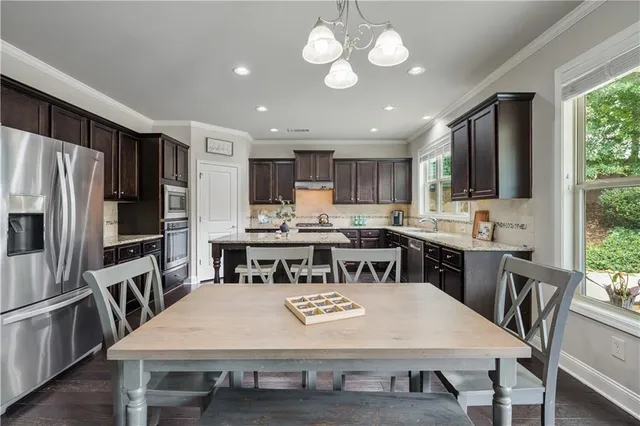 a kitchen with granite countertop a stove and a sink