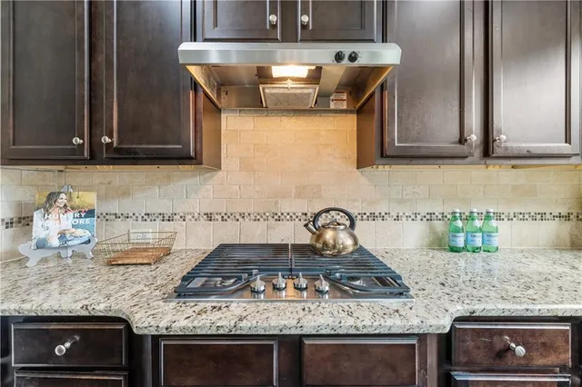 a kitchen with granite countertop a sink and a window