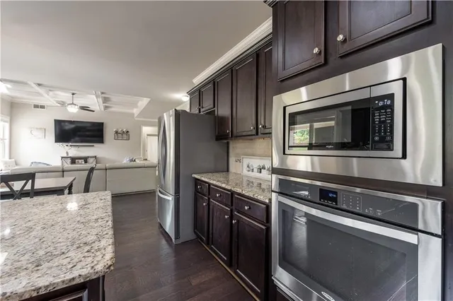 a bathroom with a granite countertop sink and a toilet