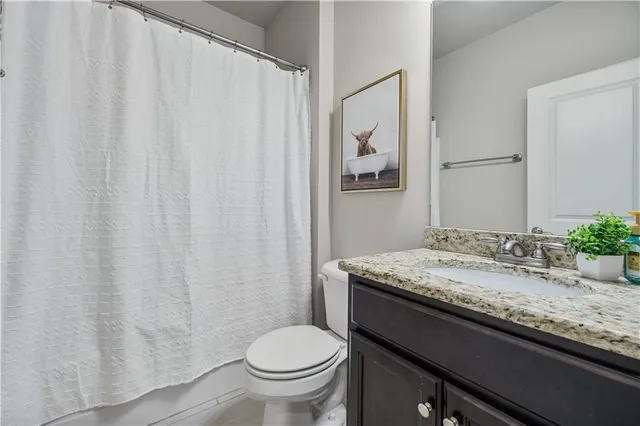 a bed sitting in a spacious bedroom next to a window
