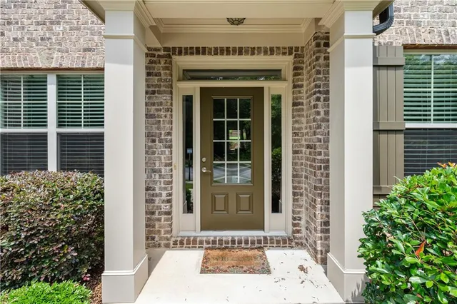 a front view of a house with a garden