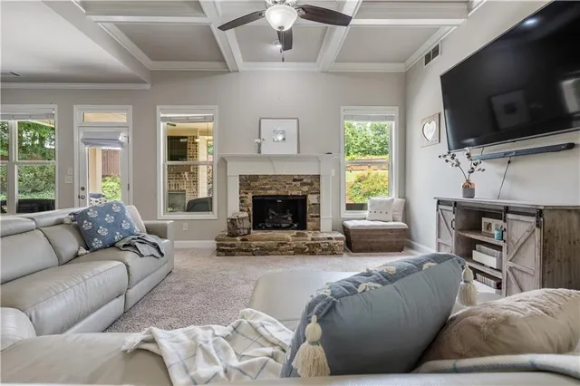 a living room with furniture and a view of kitchen