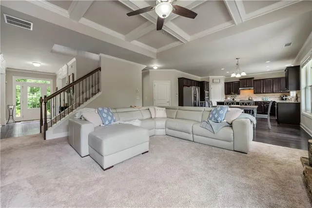 a living room with furniture a fireplace and a chandelier