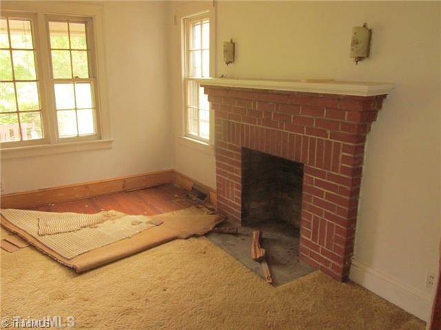 130 North Edgewood Road Eden, NC 27288 - Photo 5 of 16 Living Room. LR with FP there is evidence of extensive termite damage