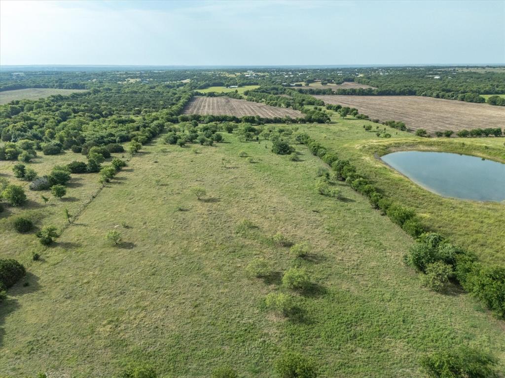 3506 County Road 1106 Rio Vista, TX 76093 - Photo 6 of 40 Aerial view of property and surrounding area with rural landscape and a nearby body of water