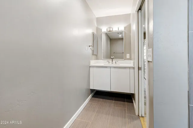 a view of bathroom with mirror and sink