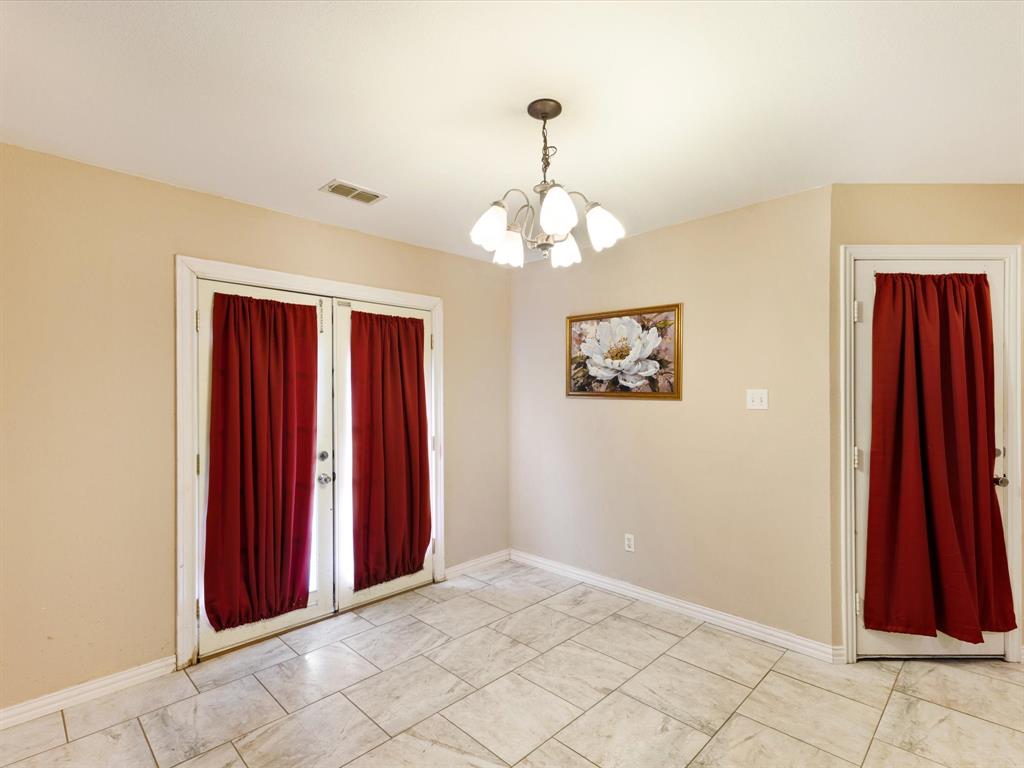 207 Quail Run Aubrey, TX 76227 - Photo 7 of 30 Foyer entrance featuring hanging lights and baseboards