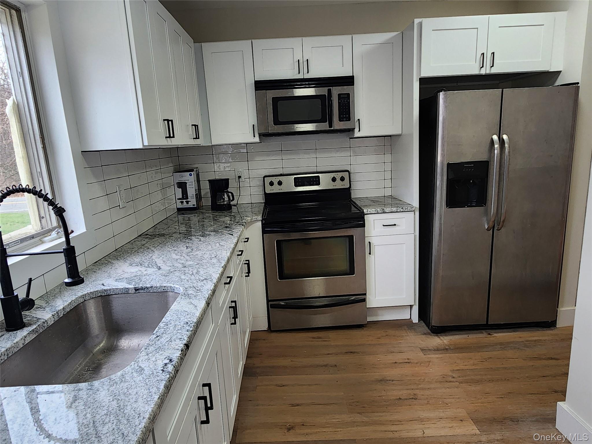 20 Hankins Road Hankins, NY 12741 - Photo 10 of 30 a kitchen with stainless steel appliances granite countertop a sink stove and refrigerator
