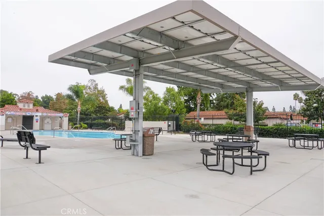 a view of patio with a table and chairs under an umbrella