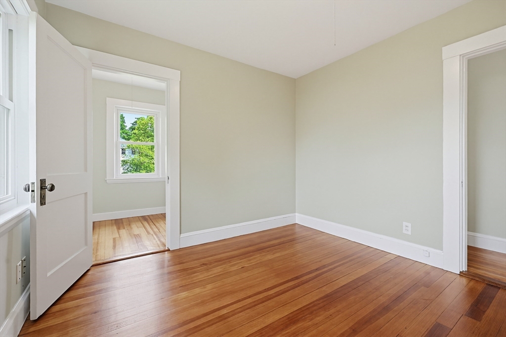 10 Water Street Natick, MA 01760 - Photo 22 of 35 an empty room with wooden floor and windows