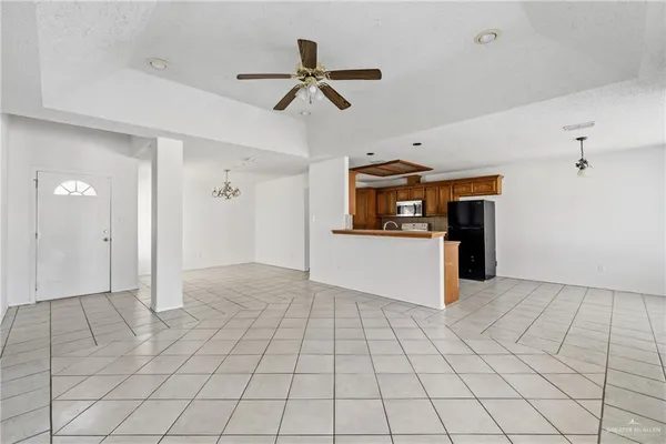 a view of a kitchen with a sink and a refrigerator