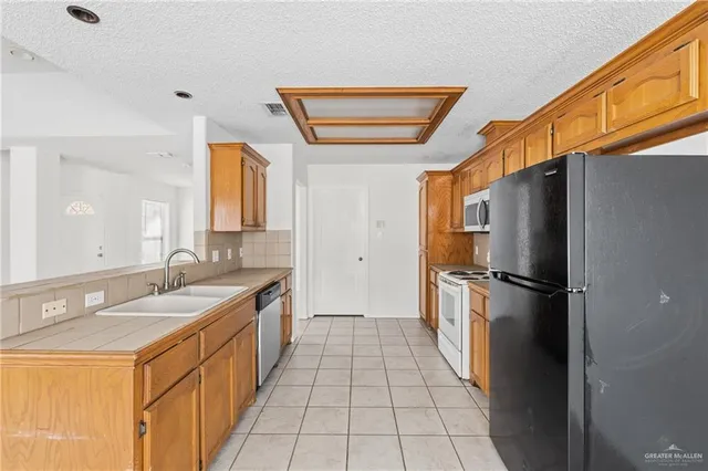 a kitchen with a refrigerator and a sink