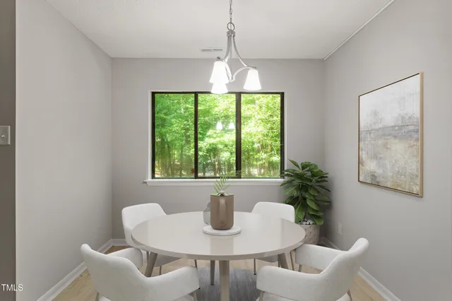 a dining room with furniture and window
