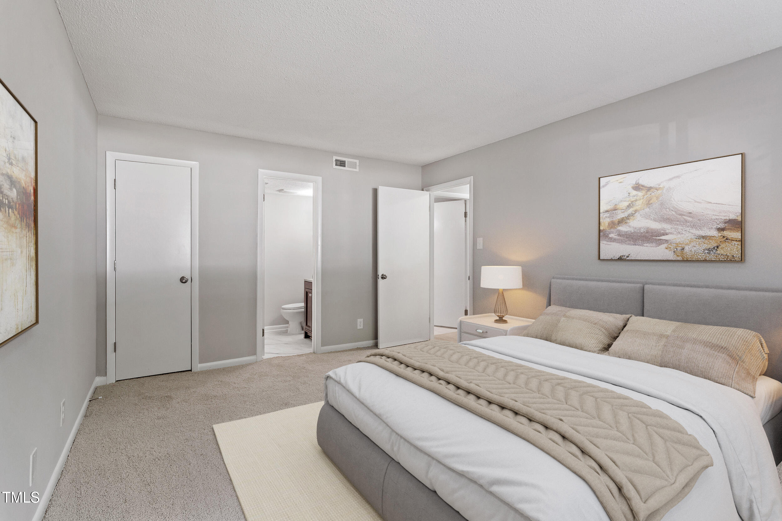 3088 Colony Road, Unit A Durham, NC 27705 - Photo 4 of 24 a spacious bedroom with a bed and a painting on the wall