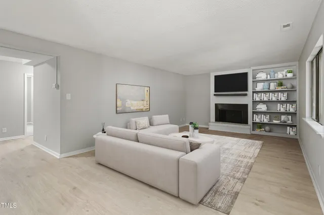 a living room with furniture a rug and a fireplace