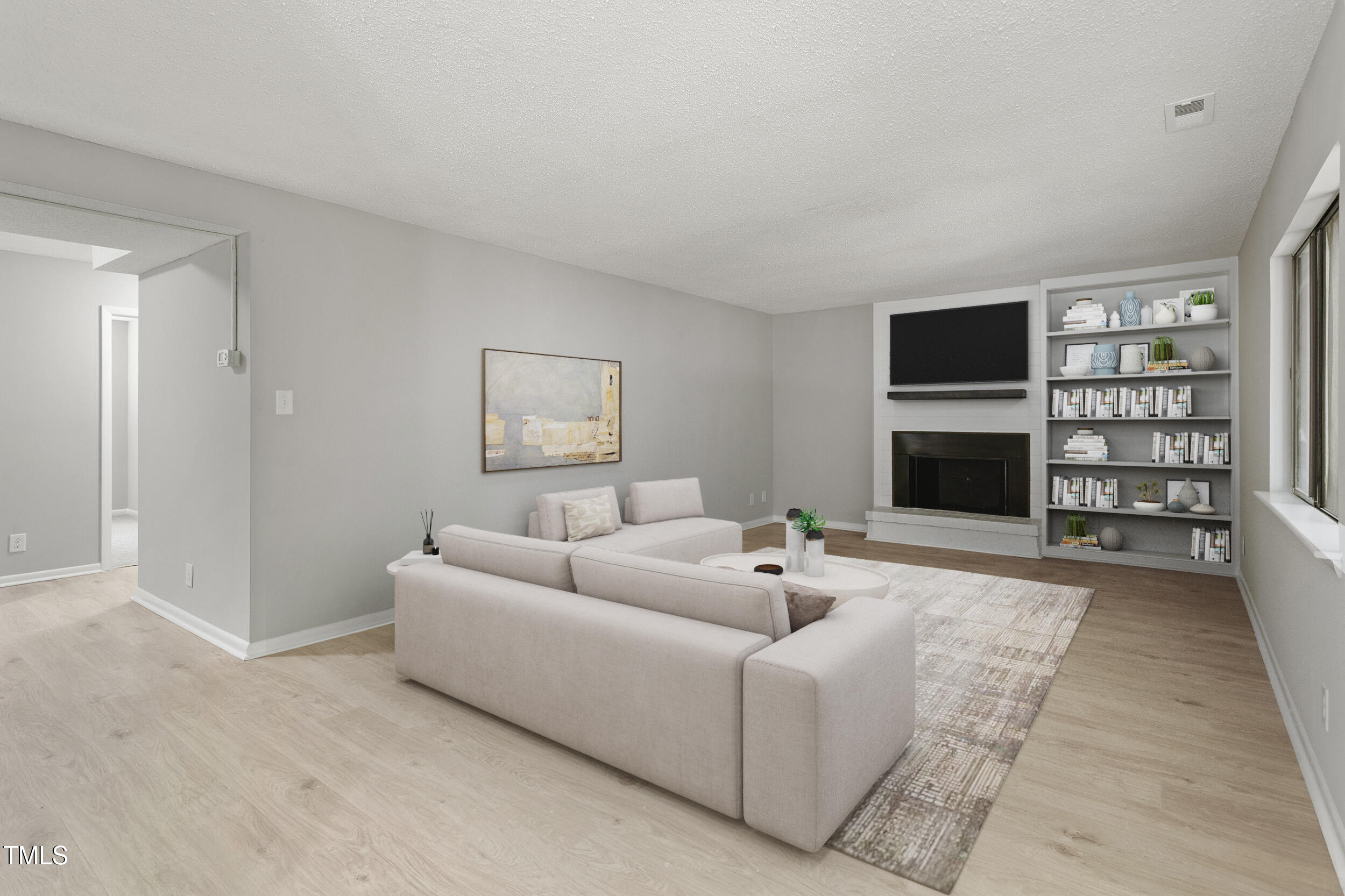 3088 Colony Road, Unit A Durham, NC 27705 - Photo 5 of 24 a living room with furniture a rug and a fireplace