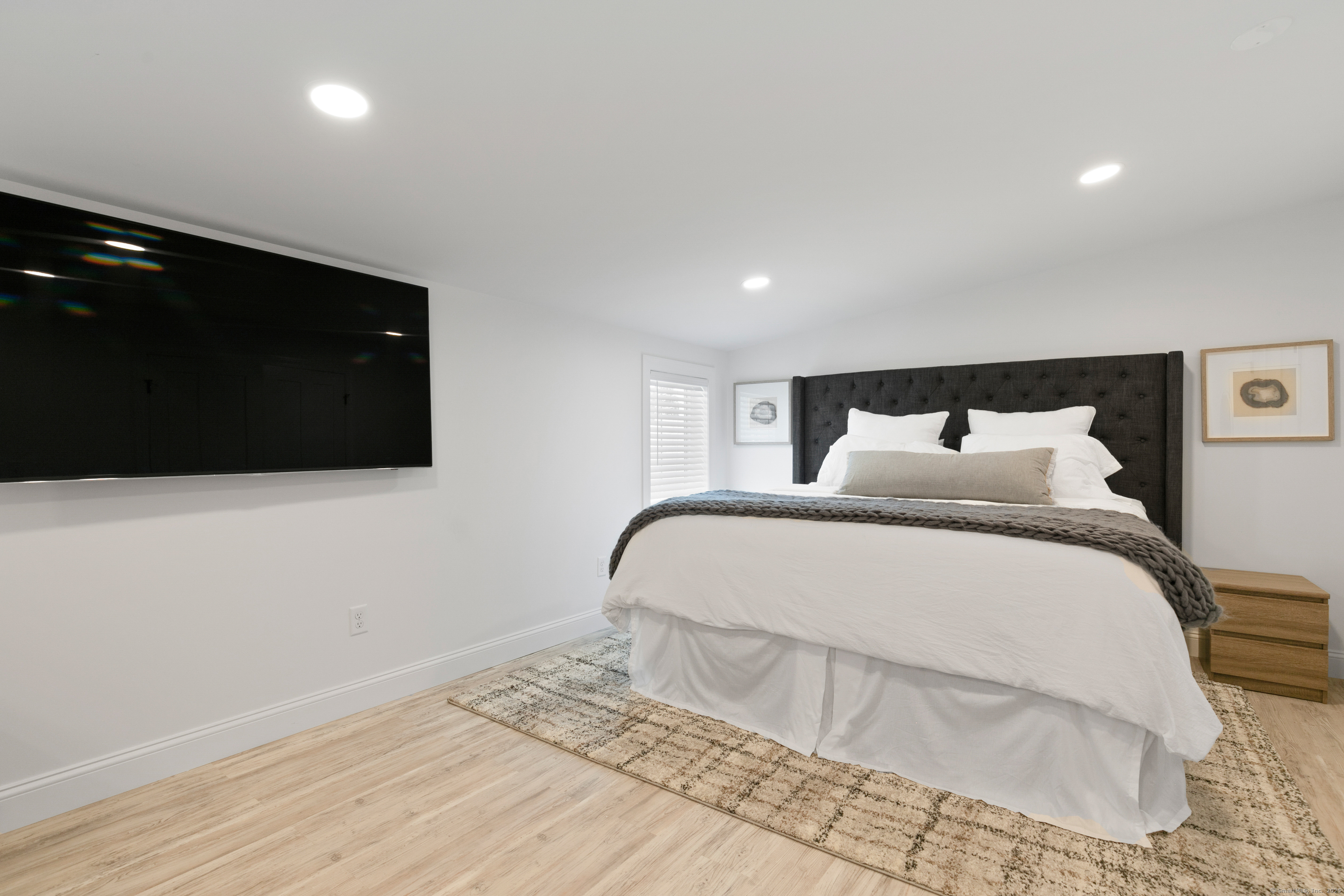 44 Williams Avenue, Unit PH Stonington, CT 06355 - Photo 11 of 25 a bedroom with a bed and a flat screen tv