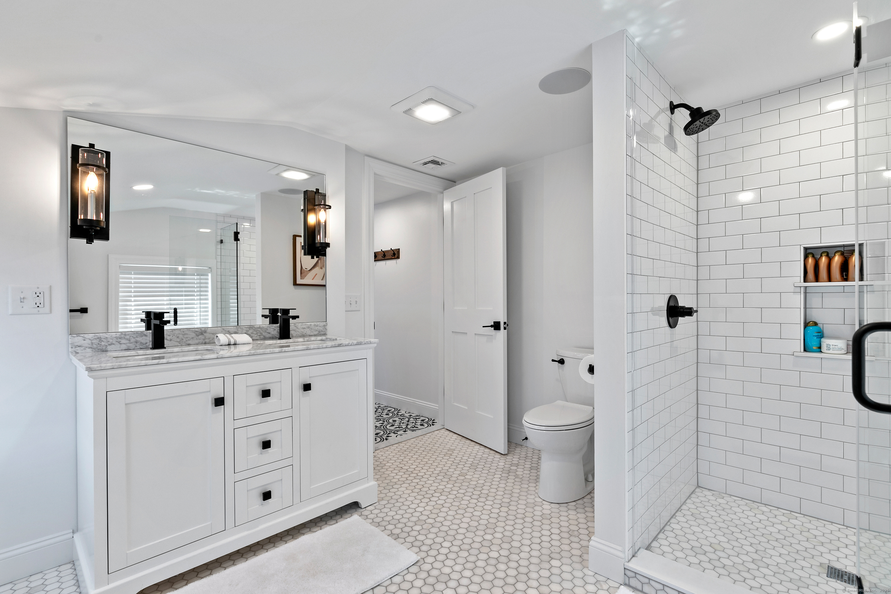 44 Williams Avenue, Unit PH Stonington, CT 06355 - Photo 18 of 25 a bathroom with a double vanity sink toilet and shower