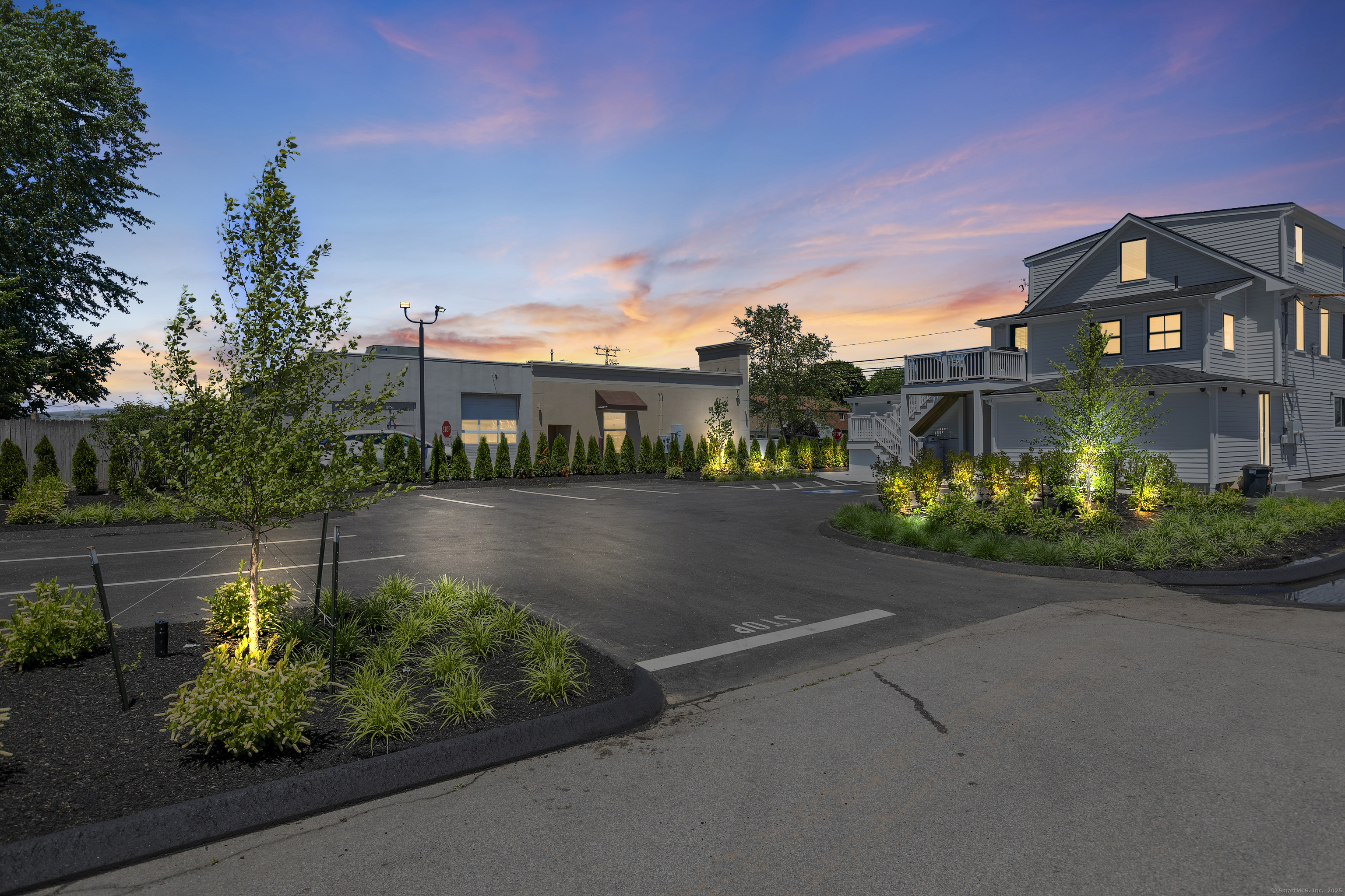 44 Williams Avenue, Unit PH Stonington, CT 06355 - Photo 2 of 25 a front view of a house with a garden and plants