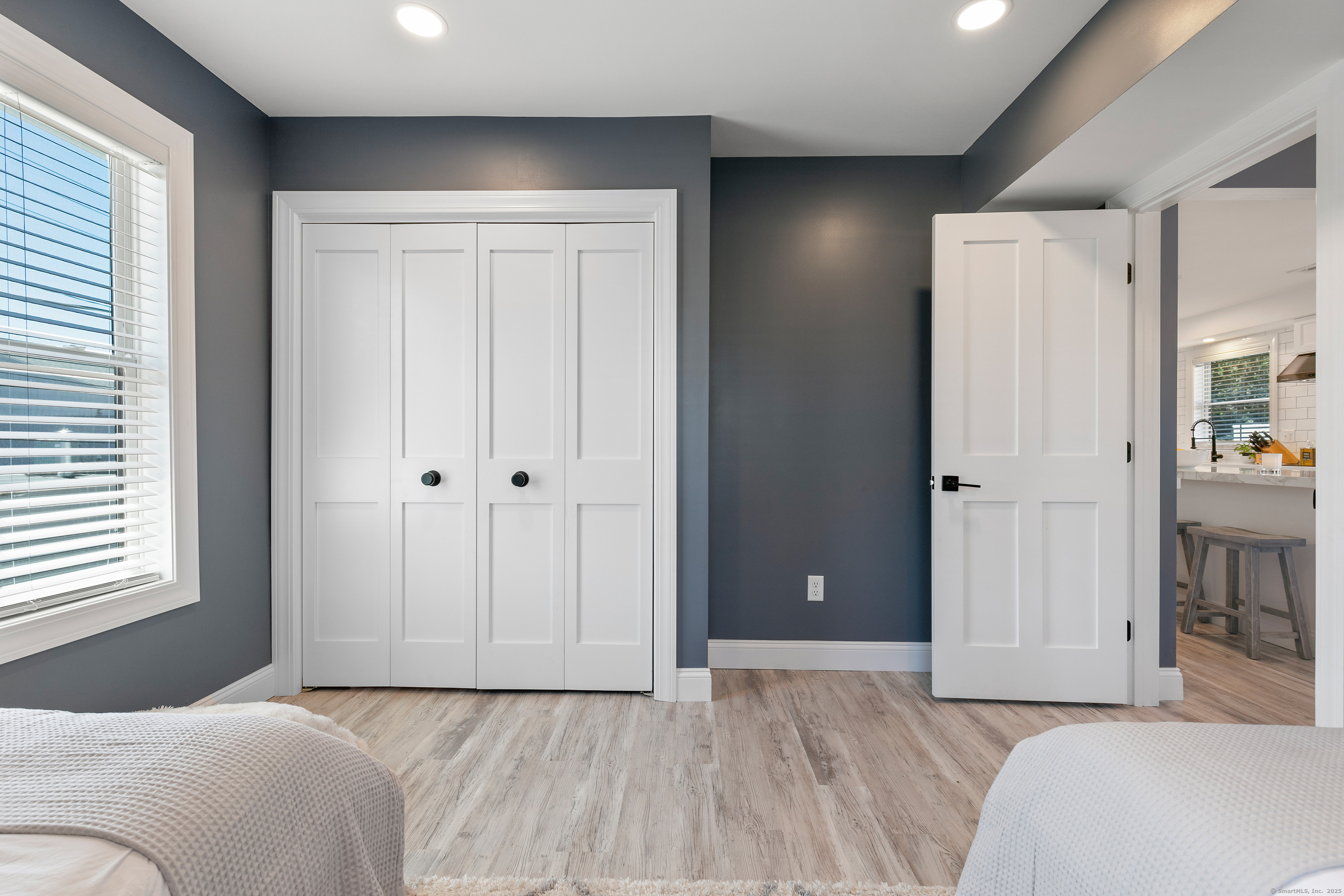 44 Williams Avenue, Unit PH Stonington, CT 06355 - Photo 21 of 25 a bedroom with a bed and a window