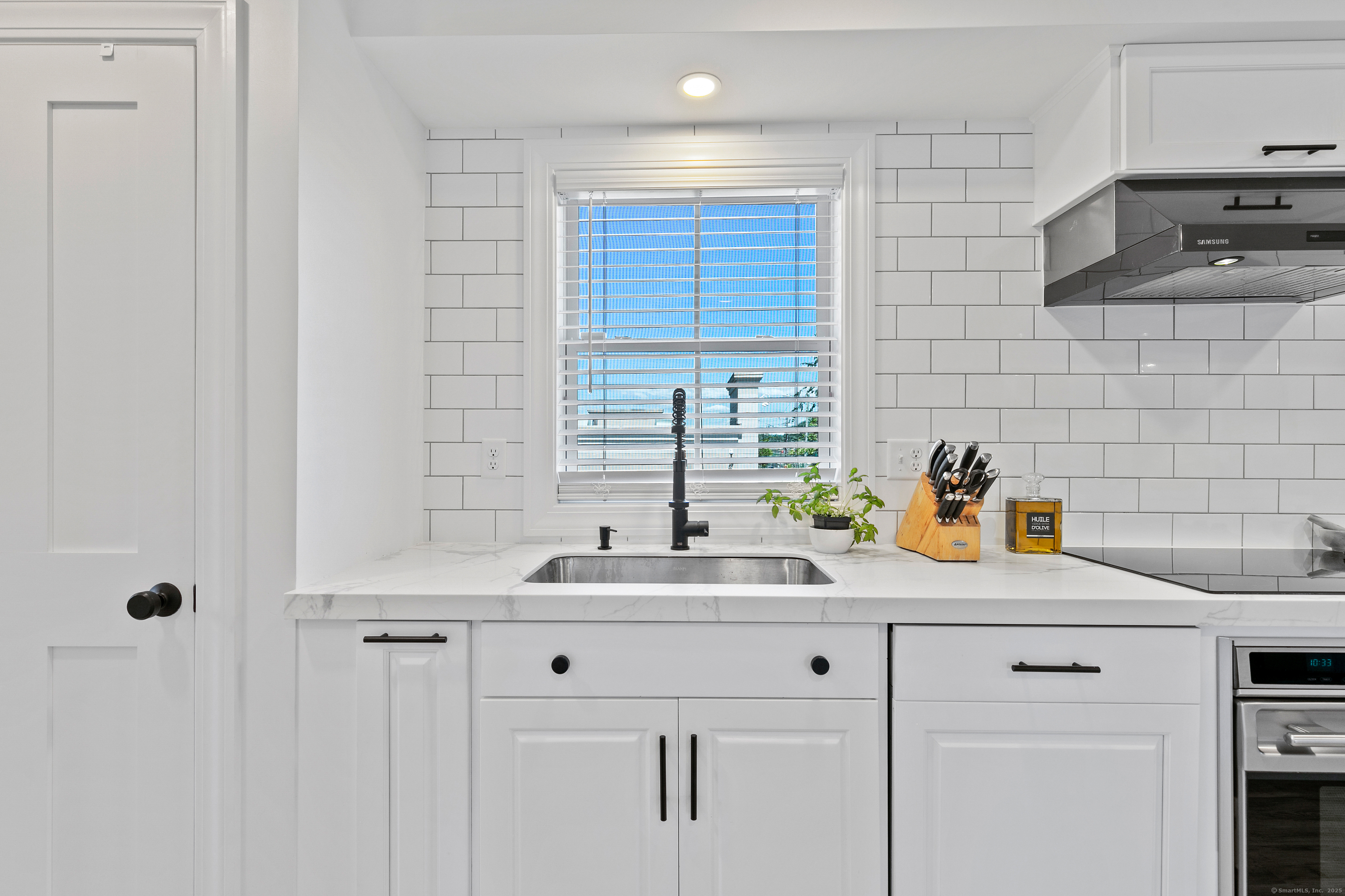 44 Williams Avenue, Unit PH Stonington, CT 06355 - Photo 4 of 25 a kitchen with a sink cabinets and a window