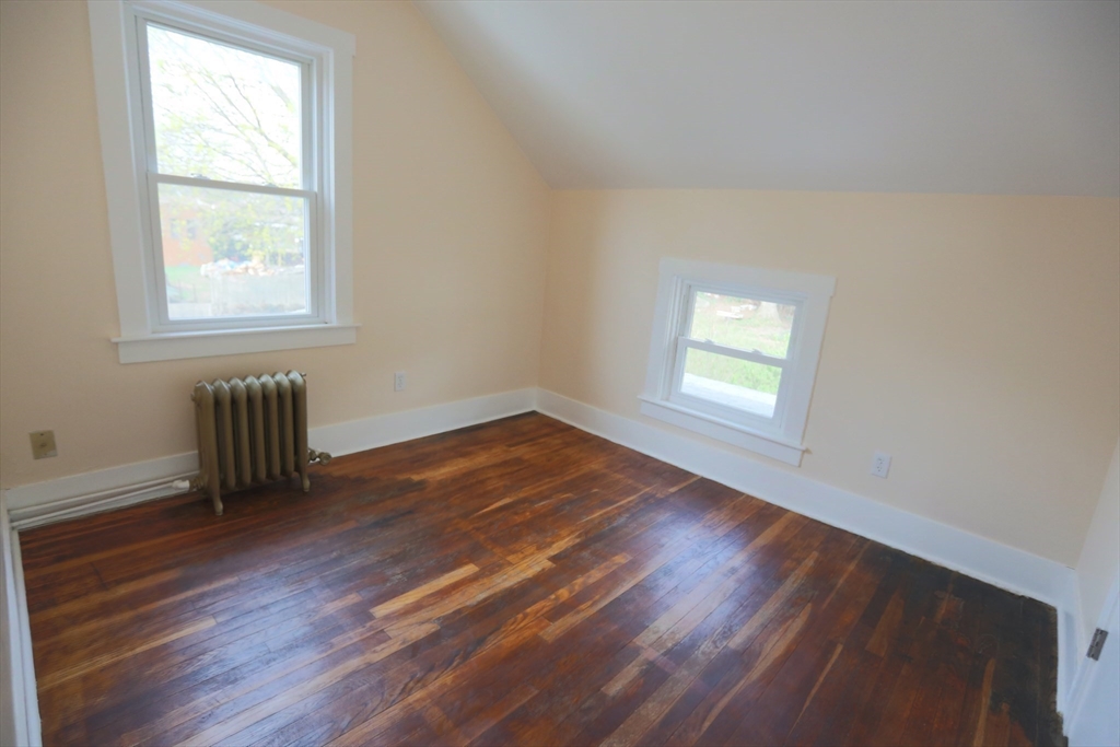 134 Baldwin Street, Unit 2 Fall River, MA 02720 - Photo 18 of 30 an empty room with wooden floor and windows