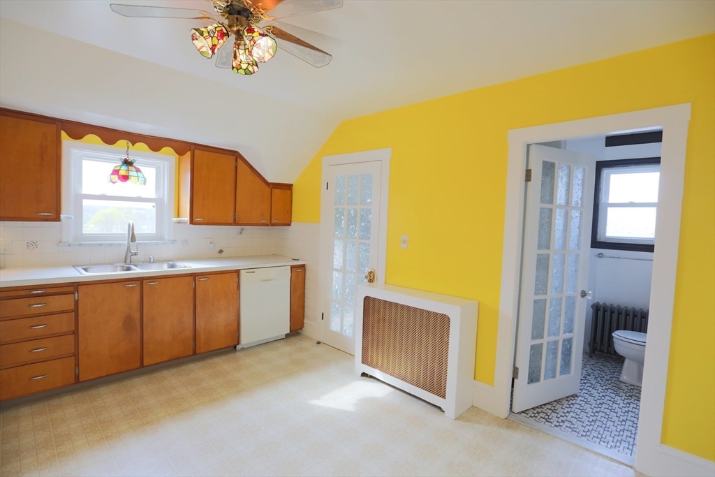 134 Baldwin Street, Unit 2 Fall River, MA 02720 - Photo 3 of 30 a view of a kitchen with a sink cabinet and a window