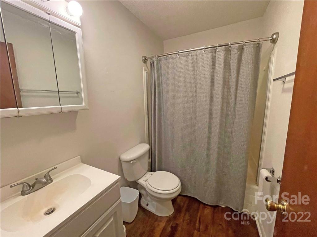 4887 County Home Road, Unit A1J2 Conover, NC 28613 - Photo 18 of 28 a bathroom with a sink a toilet and shower curtain