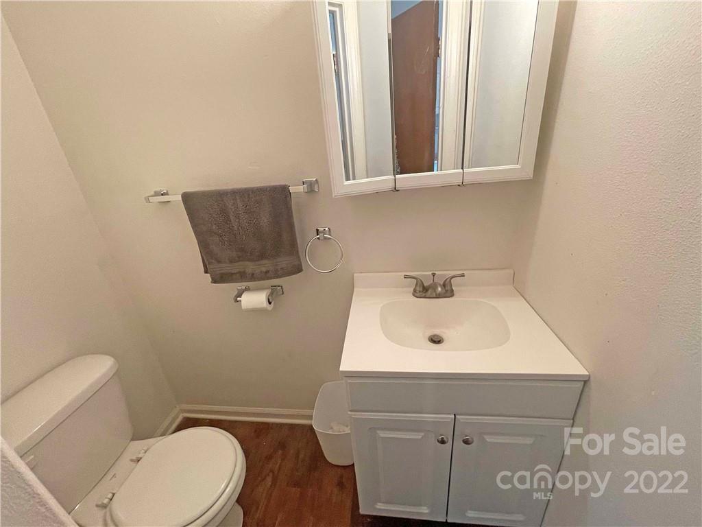 4887 County Home Road, Unit A1J2 Conover, NC 28613 - Photo 19 of 28 a bathroom with a toilet a sink and mirror